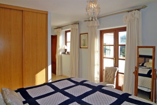 Bedroom with balcony access and integrated closet
