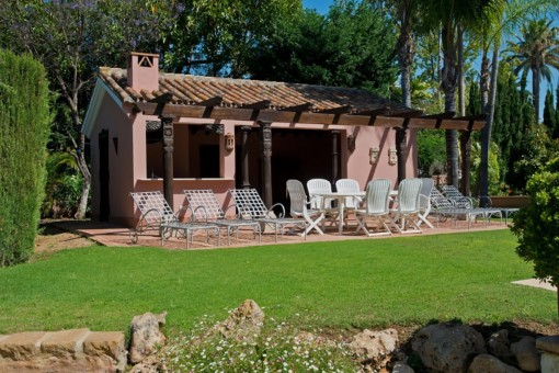 Garden house with sunbeds and wooden beams